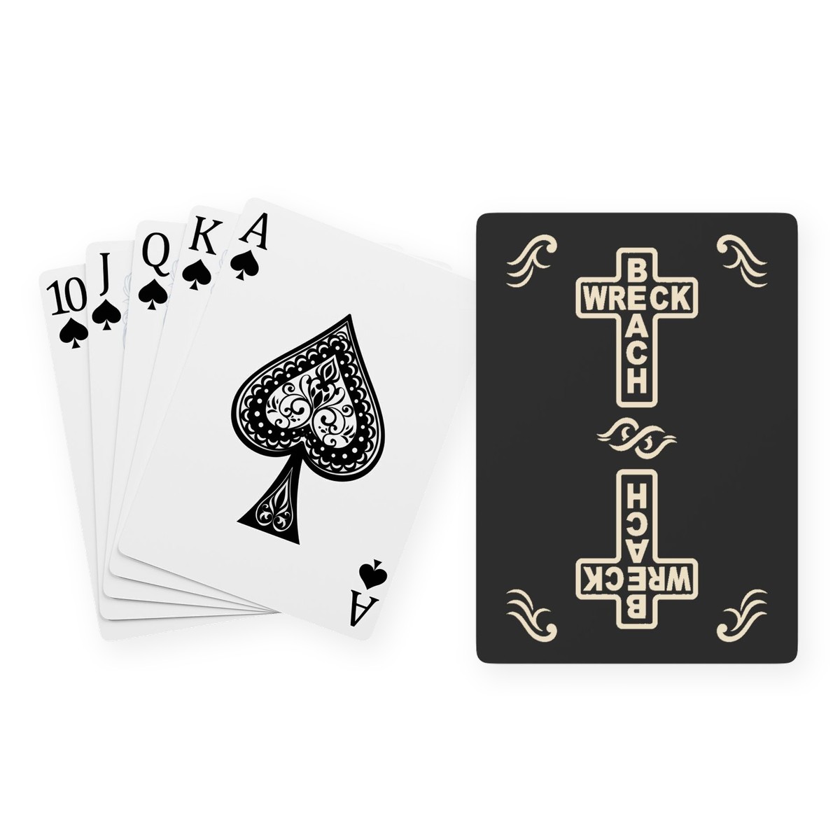 A poker hand of spades fanned out beside a black playing card back printed with two mirrored cream crosses spelling Wreck and Beach